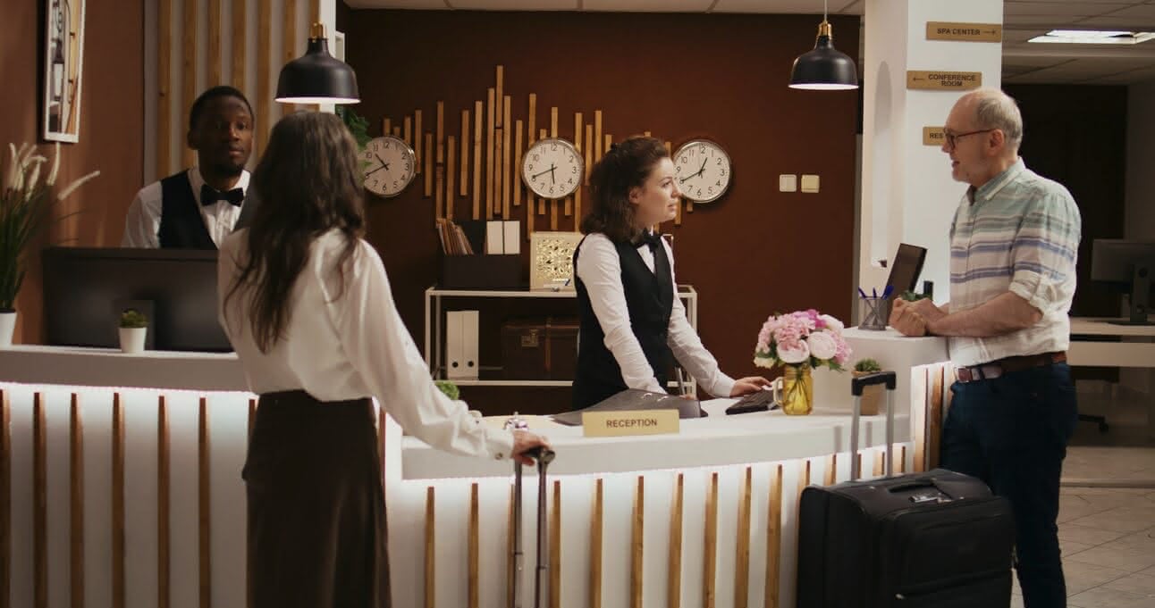 Guests checking in at a hotel front desk
